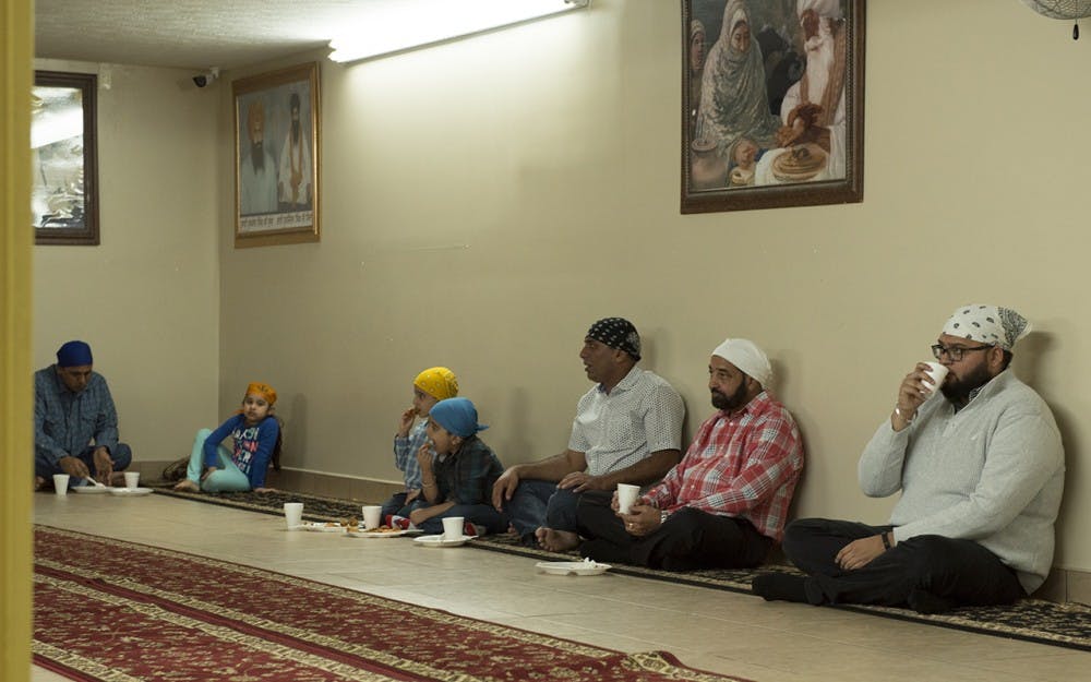 Sikhism practitioners having a meal at the basement of a Sikh Gurdwara in Fishers, Ind. They believe that having meals on the floor promotes equality. 