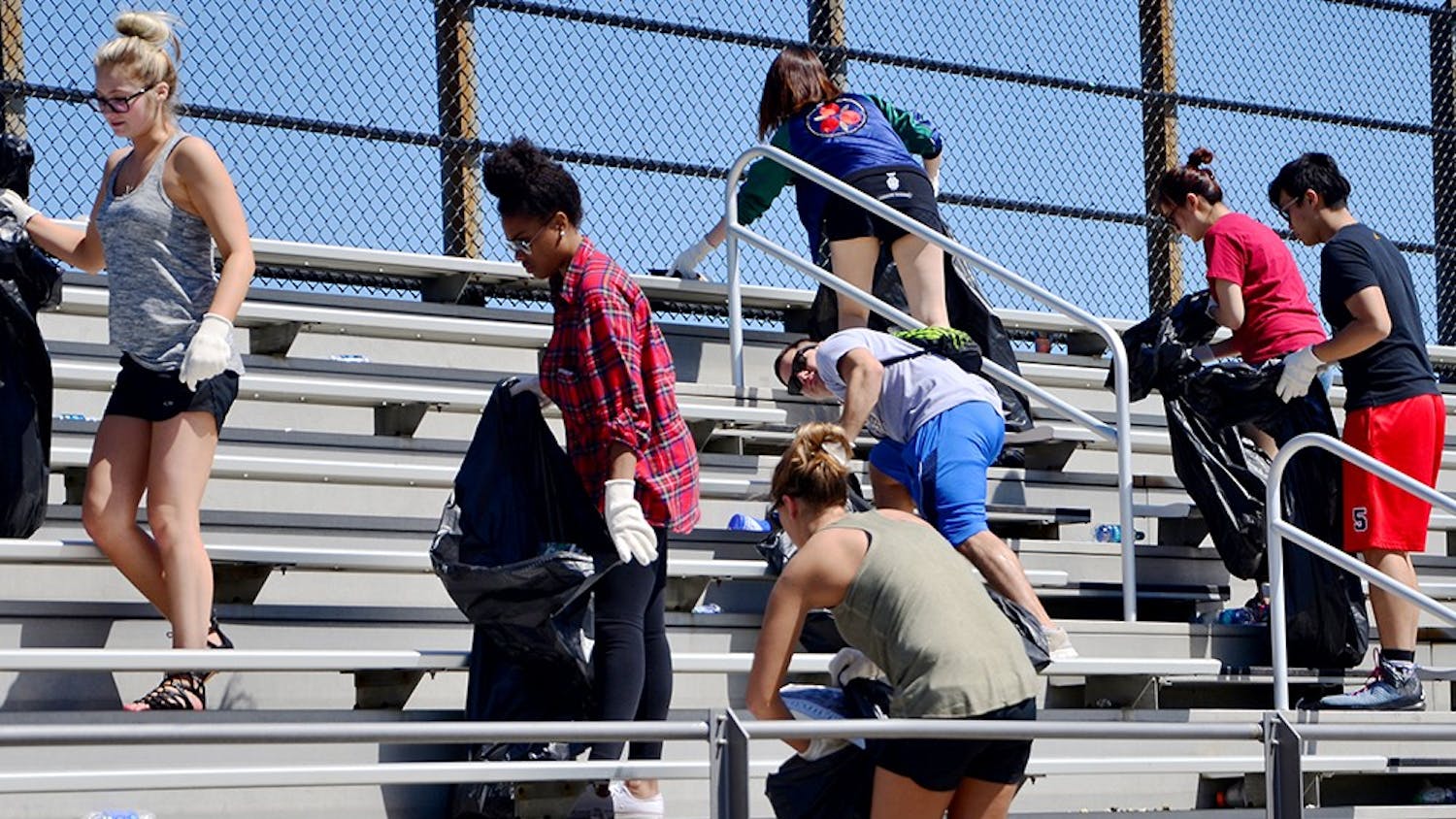Students who have received a drinking violation ticket during the Little 5 weekend pick up trashes as a part of the pretrial diversion program Sunday at the Bill Armstrong Stadium 