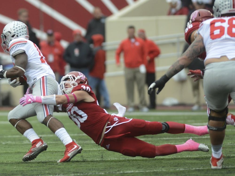 Safety Chase Dutra tackles the runner during a 2015 game against Ohio State at Memorial Stadium. Now a fifth-year senior, Dutra is a key part of IU's special teams units this season.