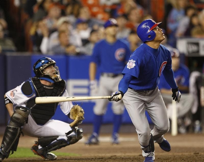 Chicago Cubs' Kosuke Fukudome, of Japan, looks up as he pops out to with two men on base to New York Mets shortstop Jose Reyes during the sixth inning of a baseball game on Wednesday at Shea Stadium in New York. Mets catcher Brian Schneider, left, looks on.