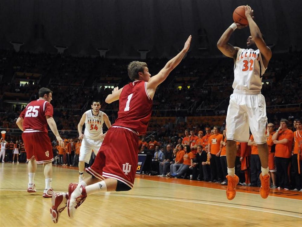 Sophomore guard Jordan Hulls tries to block Illinois' Demetri McCamey during IU's 72-48 loss to the Illini on Saturday at Assembly Hall in Champaign, Ill.