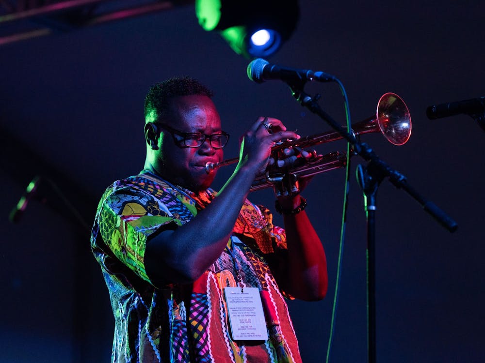 A member of the Nyansapo Highlife Band plays the trumpet Sept. 23, 2022, in the Sixth Street tent during the Lotus World Music and Arts Festival. The group has over 30 years of experience and has been nominated for the Best African Highlife Band several times in the Chicago Music Awards.