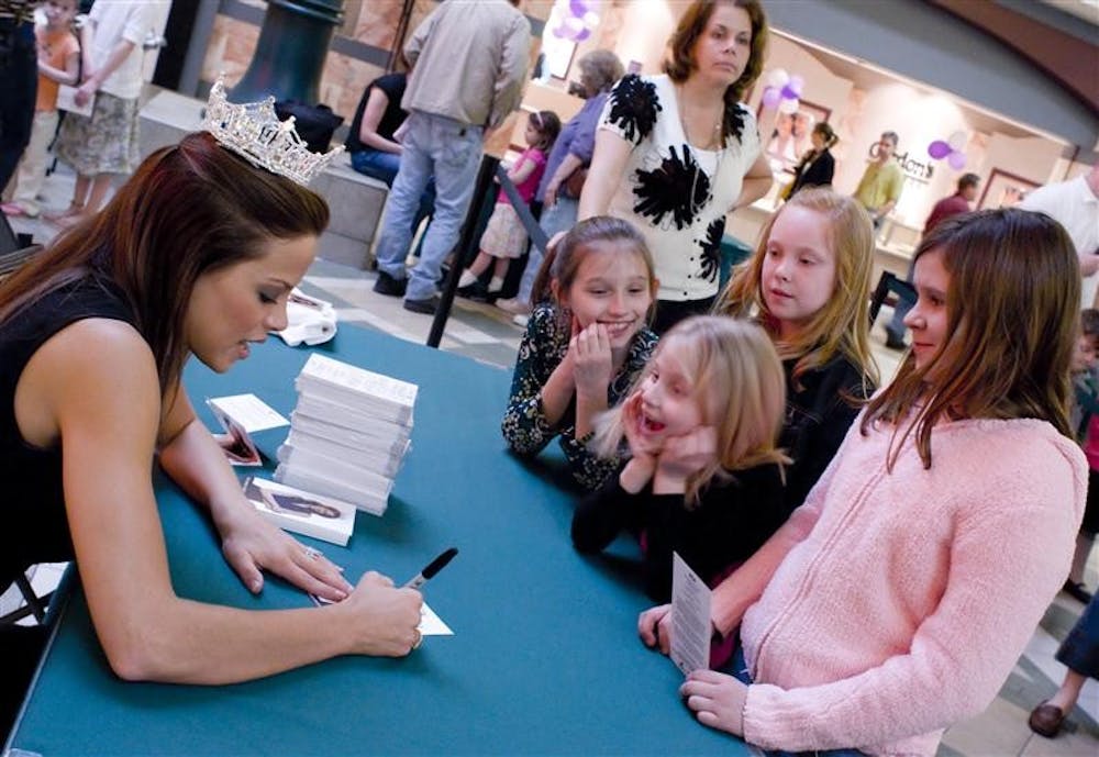 Miss America Katie Stam signs autographs Sunday afternoon for young girls at the College Mall. Katie Stam is Indiana's first Miss America.