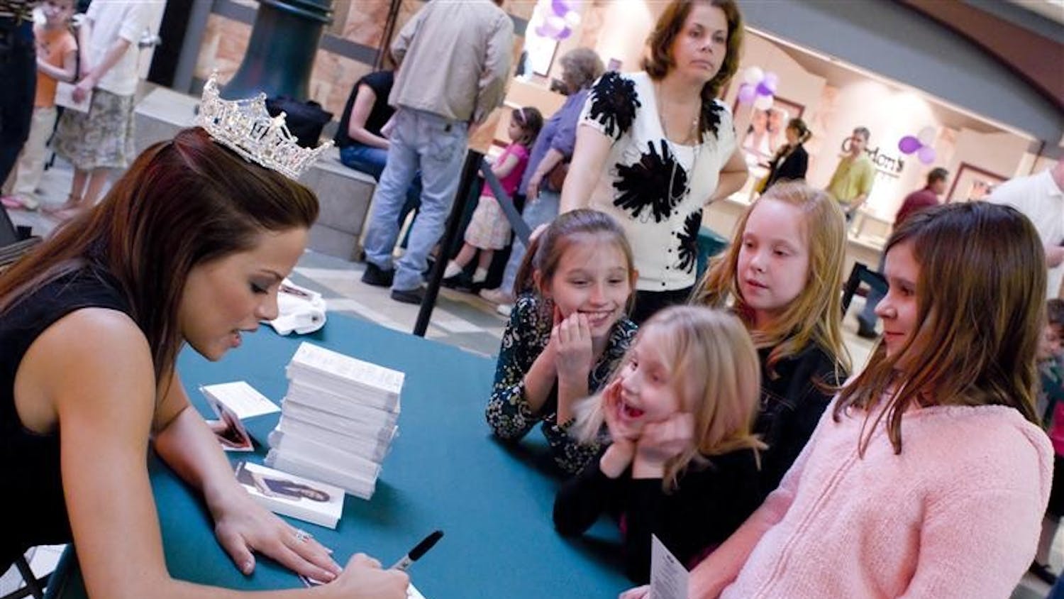 Miss America Katie Stam signs autographs Sunday afternoon for young girls at the College Mall. Katie Stam is Indiana's first Miss America.