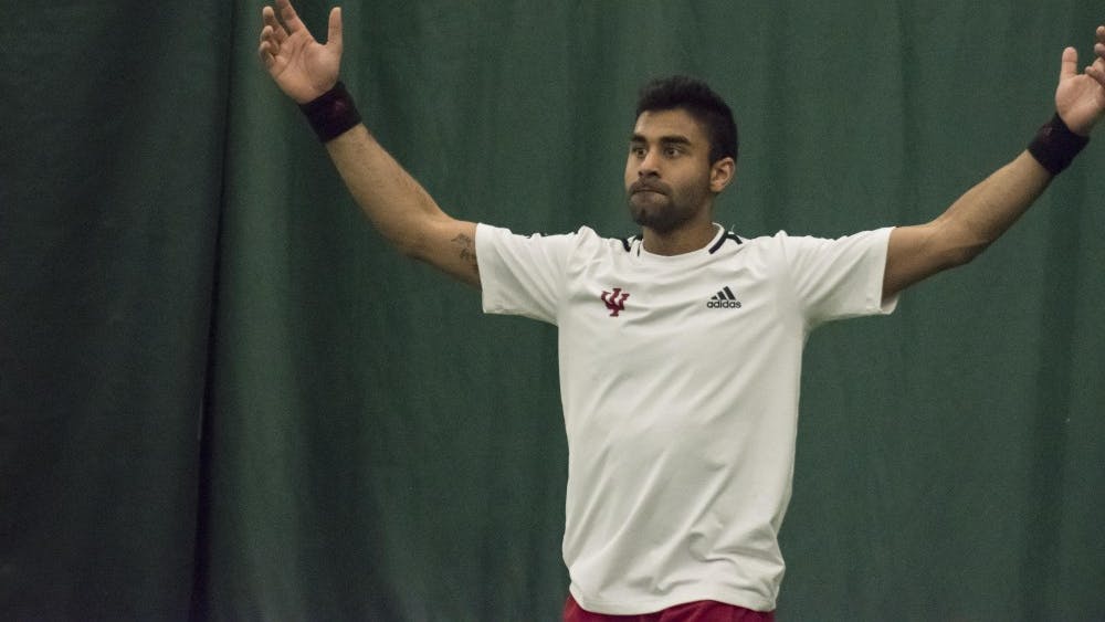 Senior Raheel Manji celebrates his 3-6, 6-3, 6-2 singles win over Wisconsin on Sunday at the Indiana University Tennis Center. The Hoosiers will face Penn State and Ohio State at home this weekend.