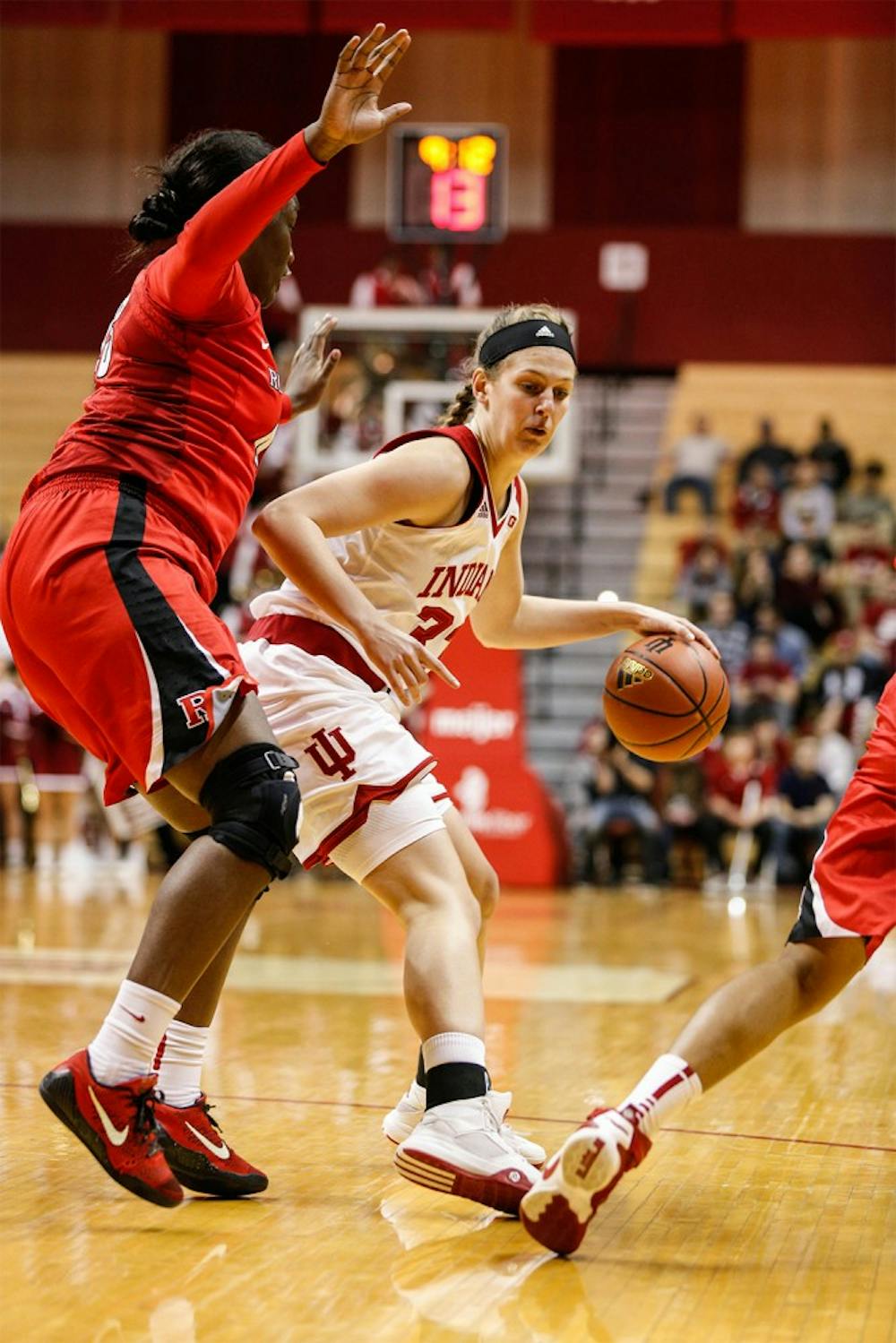 Sophomore guard Amanda Cahill moves the ball to the basket against a Rutgers player. Cahill was second in scoring against Rutgers with 12 points to help secure a 64-48 victory on Wedensday night at Assembly Hall. 