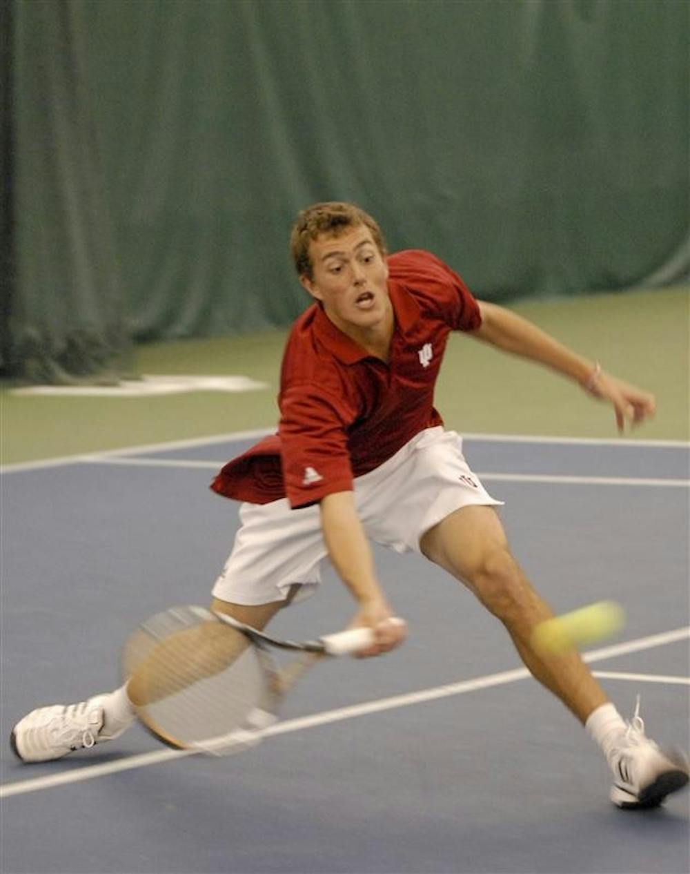 Freshman Stephen Vogl lunges for a volley against Illinois Tuesday afternoon in the Varsity Tennis Center. Vogl and partner sophomore Lachlan Ferguson dropped their match, 8–4.