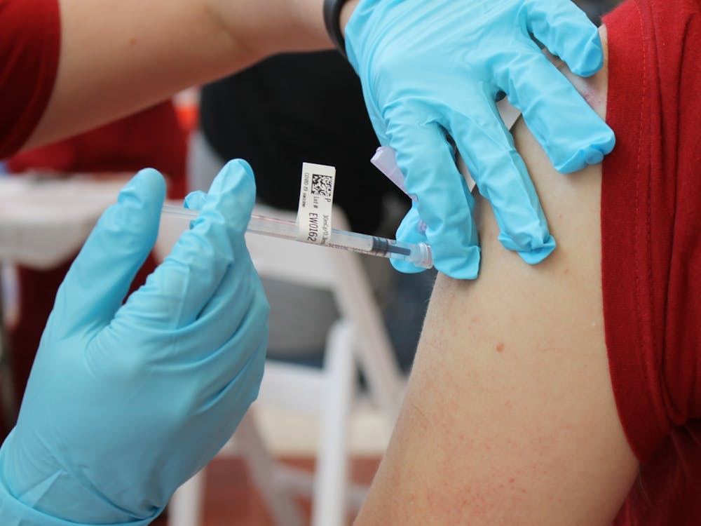 Then-junior Bryce Asher receives a COVID-19 vaccination April 12, 2021, at Simon Skjodt Assembly Hall. IU experts encouraged students to get a COVID-19 booster shot as they prepare to head home for Thanksgiving.