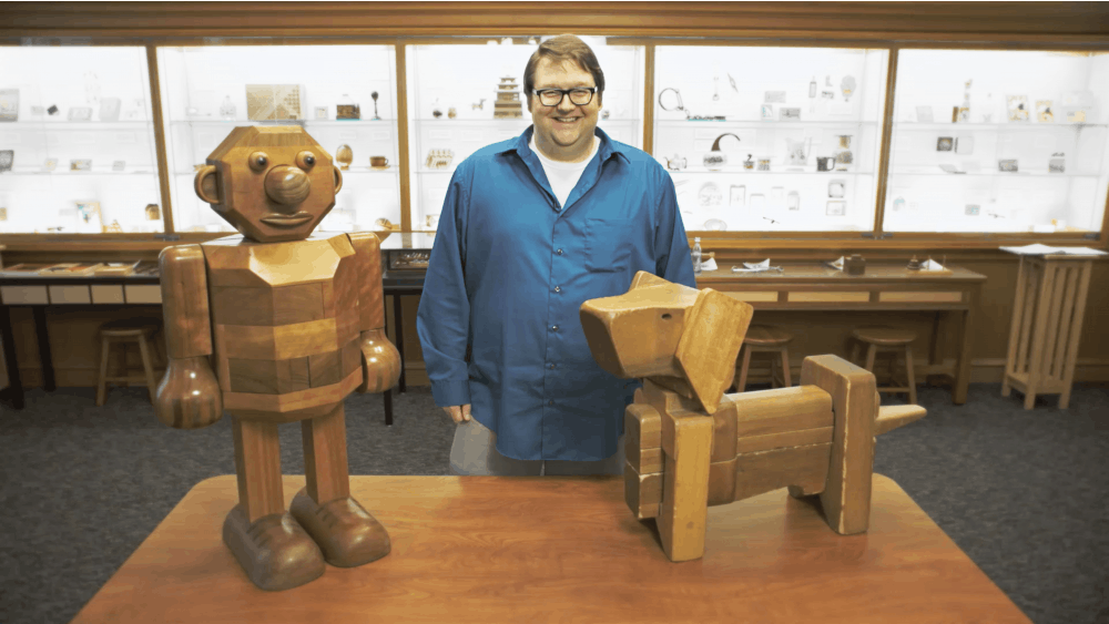 Puzzle Curator Andrew Rhoda poses with two of his wooden puzzles. There are more than 30,000 puzzles included in a collection at the Lilly Library at IU.