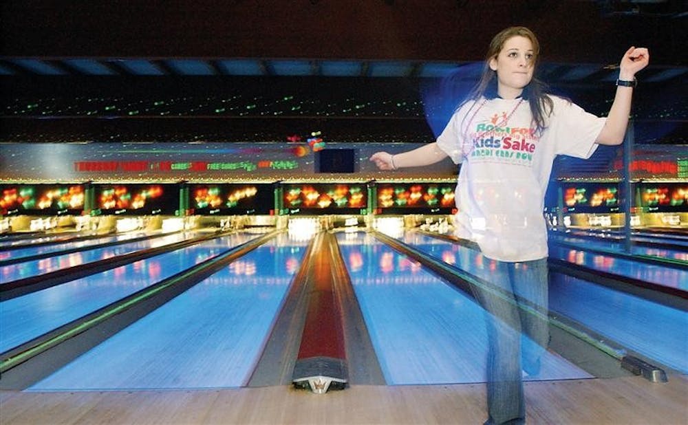 Strutting back after her turn, sophomore Rene Shaab dances back to her table at Suburban Lanes bowling alley during "Bowling for Kids Sake," a Big Brothers, Big Sisters charity bowling event December 8, 2001. 