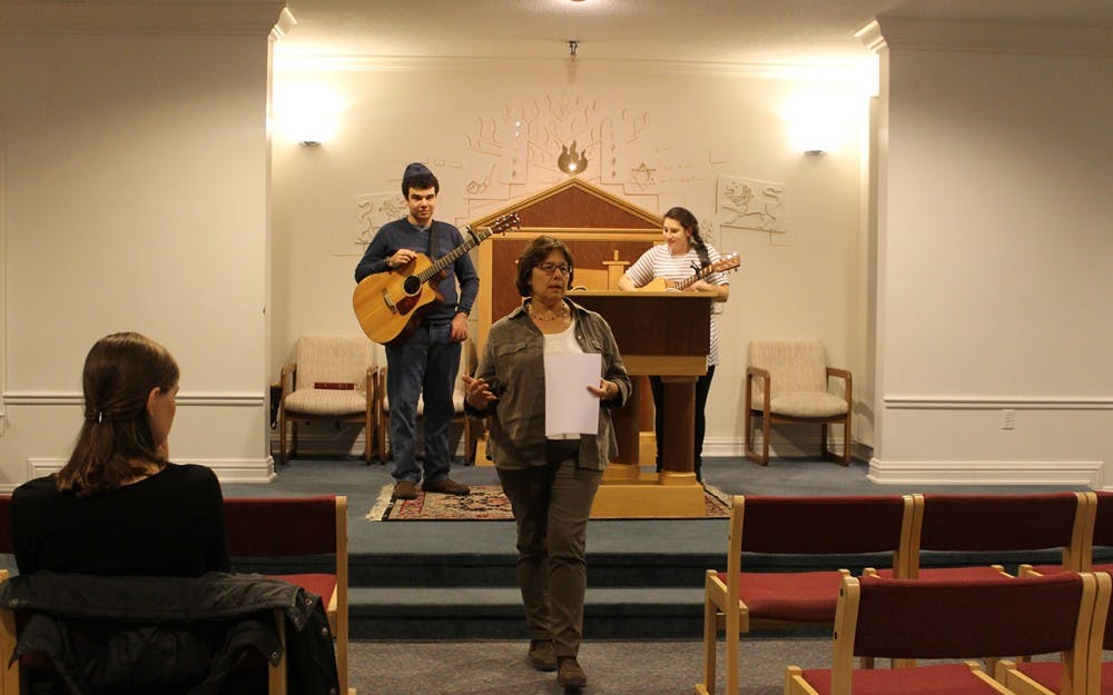 Rabbi Sue Silberberg speaks with members of "Shabbat Rocks" behind her. This event took place at Hillel located on Third Street.