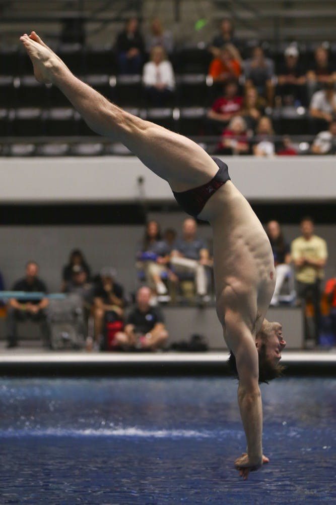 Junior Michael Hixon performs a back 2.5 somersault pike at the IUPUI natatorium on Friday, March 24, 2017 at the NCAA Swimming and Diving Championships. Hixon placed 5th in the men's 1-meter dive and 6th in the 3-meter synchro at the 2017 FINA World Championships in Budapest, Hungary.