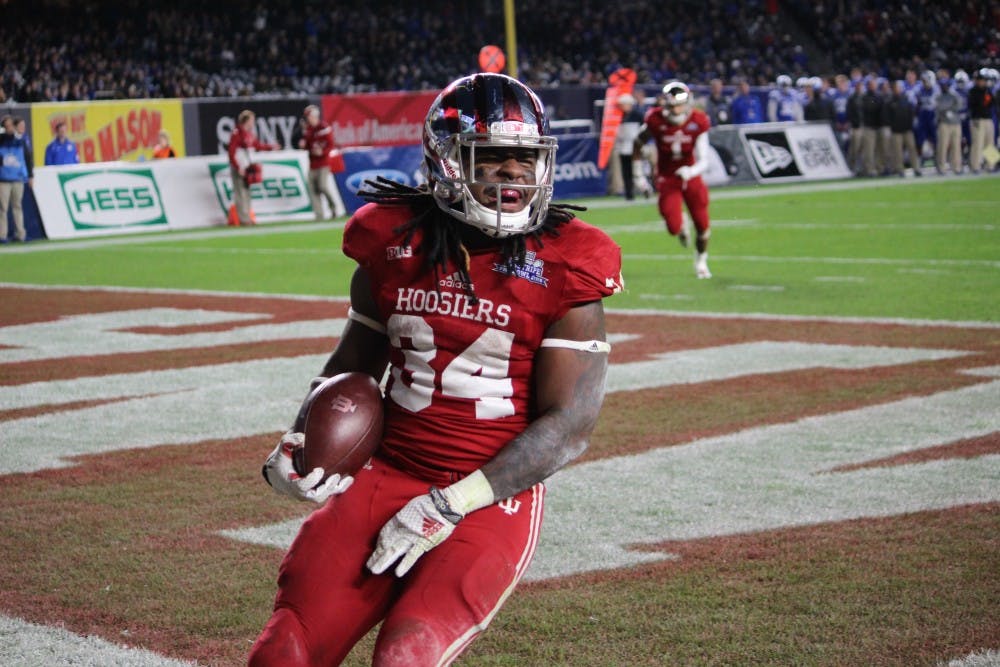 <p>Sophomore running back Devine Redding celebrates a touchdown in the second quarter of the Pinstripe Bowl on Dec. 26.&nbsp;</p>