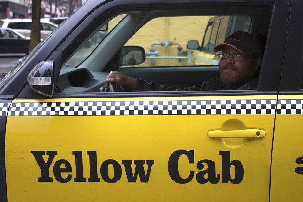 Roy Wright, a Yellow Taxi Co. driver, waits in a taxi cab to go pick up a passenger. Wright said that Uber drivers "need to be managed". Wright has worked for Yellow Taxi Co. for seven years.