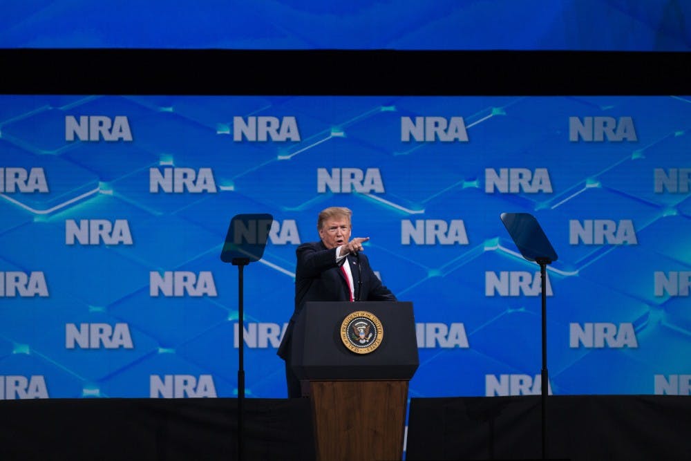 <p>President Trump points at the media and calls them &quot;fake news&quot; during the NRA-ILA Leadership Forum on April 26 in Indianapolis. Trump spoke about the history of gun violence in America, and he introduced people who have experience dealing with intruders and shooters. </p>