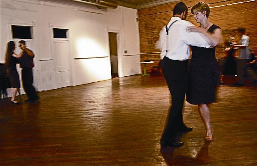 Chris Pickrell/Weekend
Amaury de Siquiera demonstrates tango moves with IU junior Elise Boruvka.