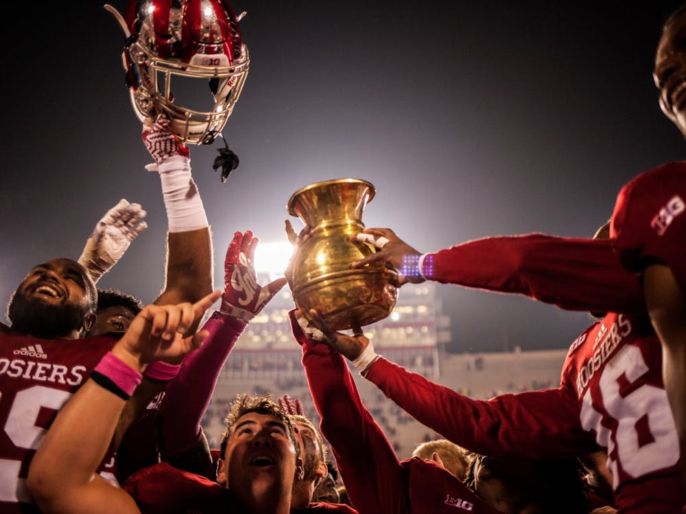 Indiana football players raise the Old Brass Spittoon after defeating Michigan State 24-21 in overtime Oct. 1, 2016, at Memorial Stadium. Indiana will try to keep the trophy at home when it plays No. 10 Michigan State Saturday.