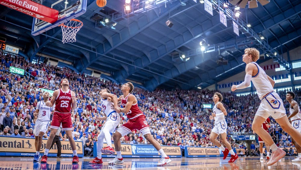 Seniors Trayce Jackson-Davis and Race Thompson look to rebound a ball Dec. 10, 2022 at the Allen Fieldhouse in Lawrence, Kansas. The Hoosiers lost to Kansas 84-62.