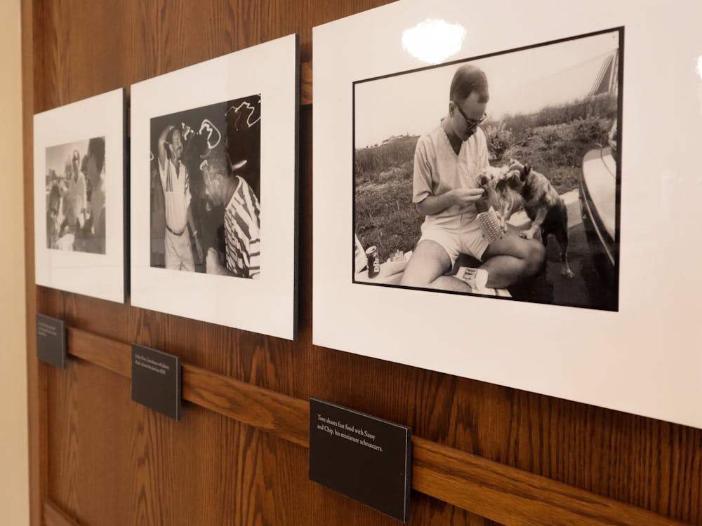 Pictures of Tom Fox sit on the wall Sept. 7 , 2022, as part of &quot;The Courageous Journey of Tom Fox&quot; exhibit at Maxwell Hall, which features sixty photographs taken by Michael A. Schwarts of Fox during his last month&#x27;s alive living with AIDS.  