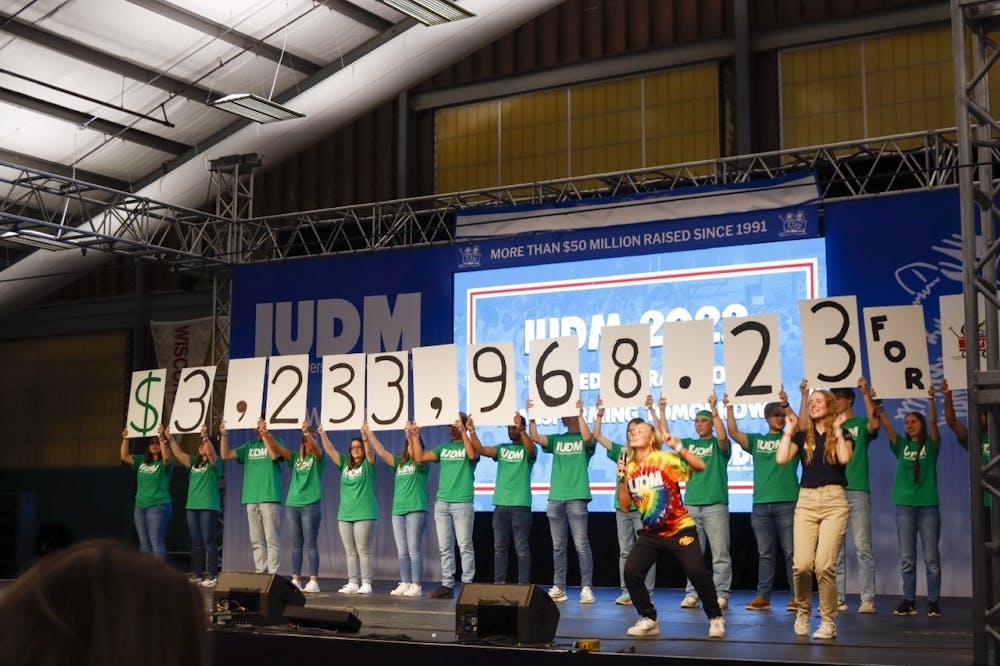 <p>﻿Indiana University Dance Marathon volunteers hold up signs during the reveal of total donations Oct. 30, 2022, at the tennis center. IUDM raised $3,233,968.23﻿ this year for Riley Children&#x27;s Hospital.</p>