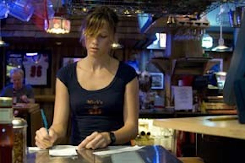 Junior Isabelle Seale tends bar at Nick's English Hut on Aug. 20.  Photo by WEEKEND Photo Editor Jay Seawell.