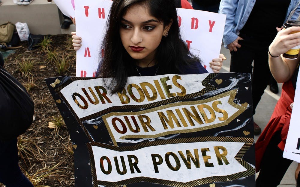 IU freshman Afeefa Iqbal holds a sign during the Women's March in Indianapolis on Saturday afternoon.&nbsp;