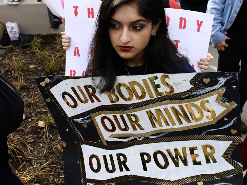 IU freshman Afeefa Iqbal holds a sign during the Women's March in Indianapolis on Saturday afternoon.&nbsp;