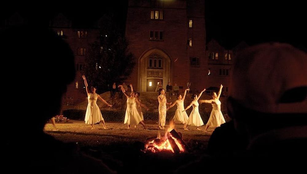 Campus community members observe the Crescent Moon dance at the Mid-Autumn Moon Festival in 2004 in front of Collins Living Learning Center. The Chinese folk song speaks to the struggle of hometown living in the modern world.