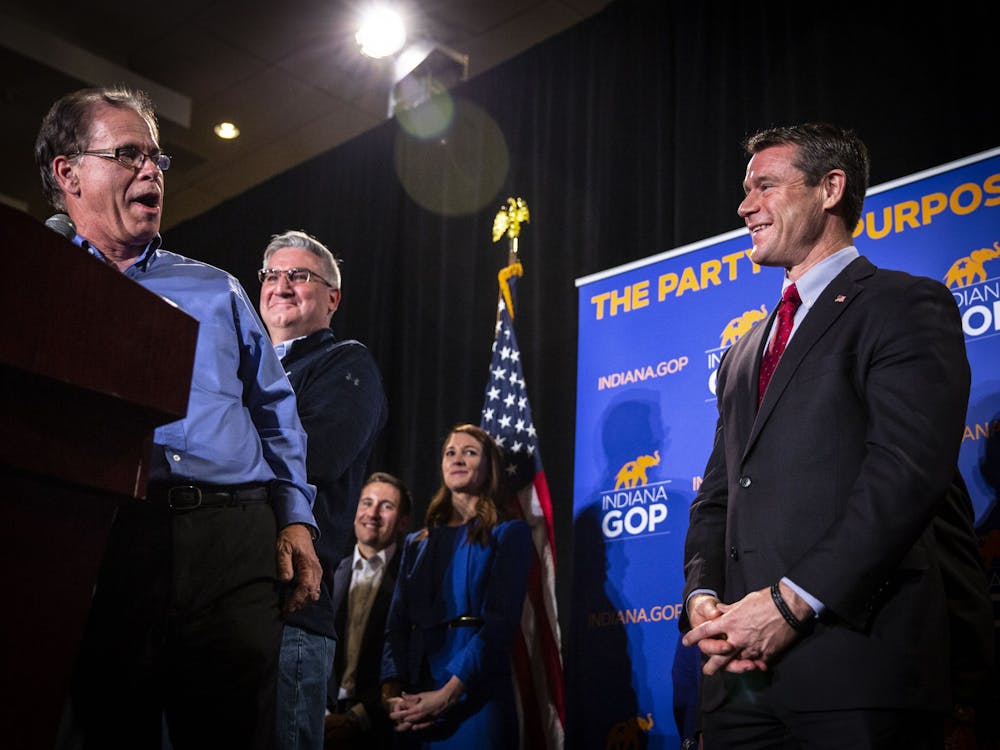 Sen. Mike Braun, R-﻿Ind., Indiana Gov. Eric Holcomb and Sen. Todd Young, R-Ind., laugh together during Braun&#x27;s victory speech Nov. 6, 2018, at the JW Marriott in Indianapolis. 