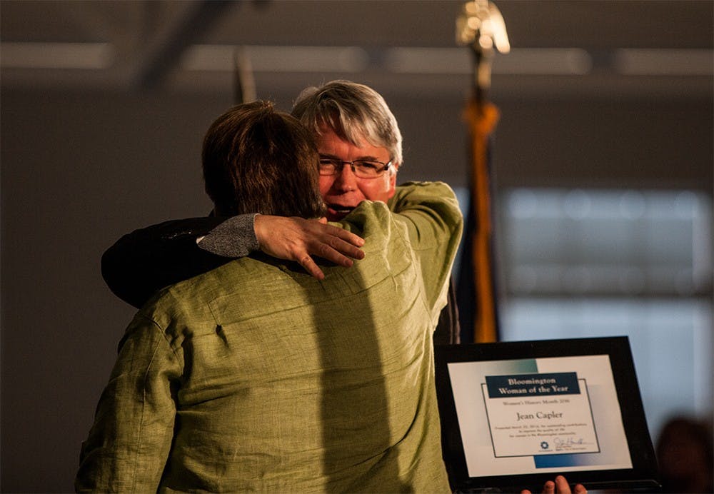 Mayor John Hamilton hugs Jean Capler, who received the Woman of the Year Award during the 31st annual Women's History Month luncheon at the Bloomington-Monroe County Convention Center on Wednesday.
