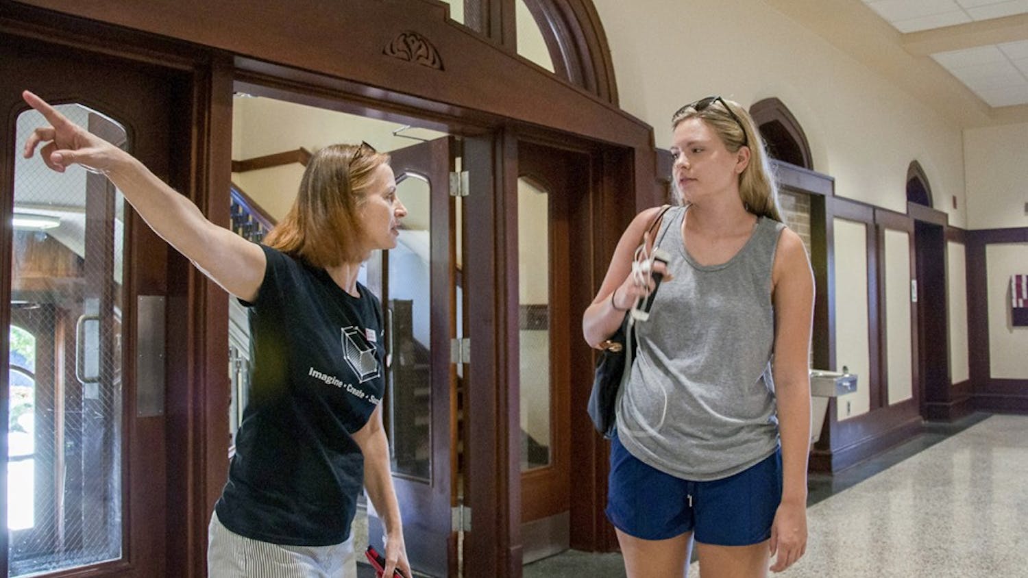 Anne Kibbler on the left, the Director of Communications and Media Relations, answers Emma Barnhard's questions about the layout of Franklin Hall on Monday morning at Franklin Hall. Now, Franklin Hall is the new building of Media School.