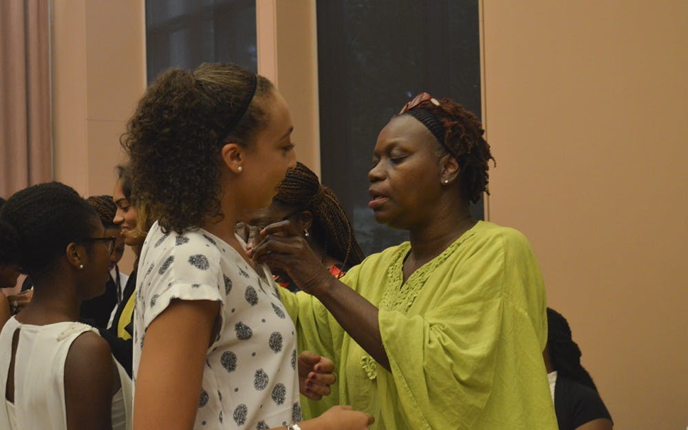 Freshman Sydney Tryon recieves her pin during the Freshman Pinning Ceremony at the Neal-Marshall Black Culture Center Thursday evening. 