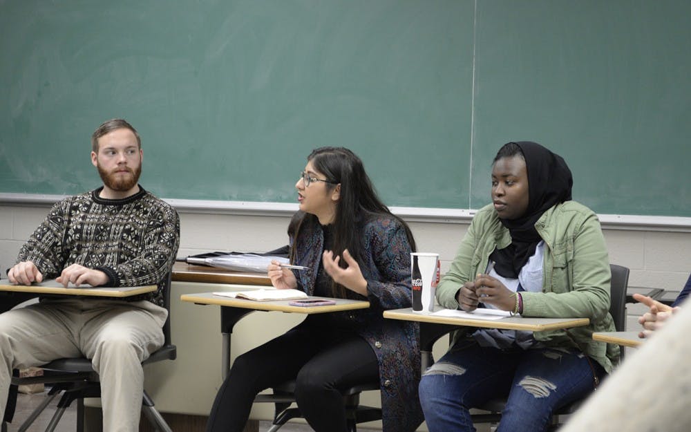 Kinza Abbas and Yassmin Fashir lead a group discussion in Ballantine 317 Sunday night. As community educators in Collins and Willkie they encourage diversity and social justice education in their communities.