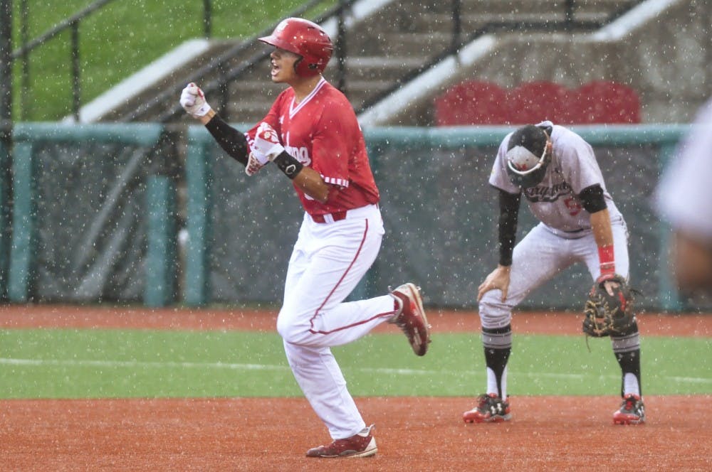 Craig Dedelow hits a grand slam in the rain in the seventh inning of game 3 against Maryland. Dedelow's grand slam gave IU a 6-3 lead immediately before the game entered a weather delay.
