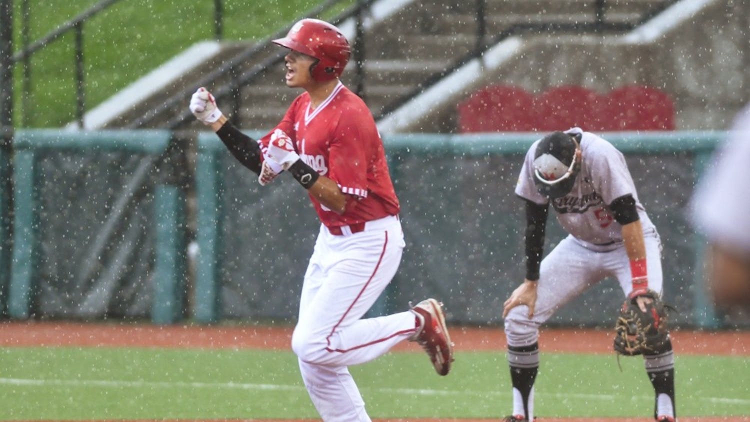 Craig Dedelow hits a grand slam in the rain in the seventh inning of game 3 against Maryland. Dedelow's grand slam gave IU a 6-3 lead immediately before the game entered a weather delay.