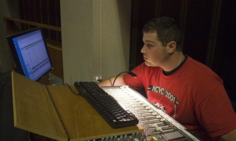Sound technician Gabe Gula makes a regular systems check for the Theater and Dramas' department production of "Dead Man Walking" before each show.