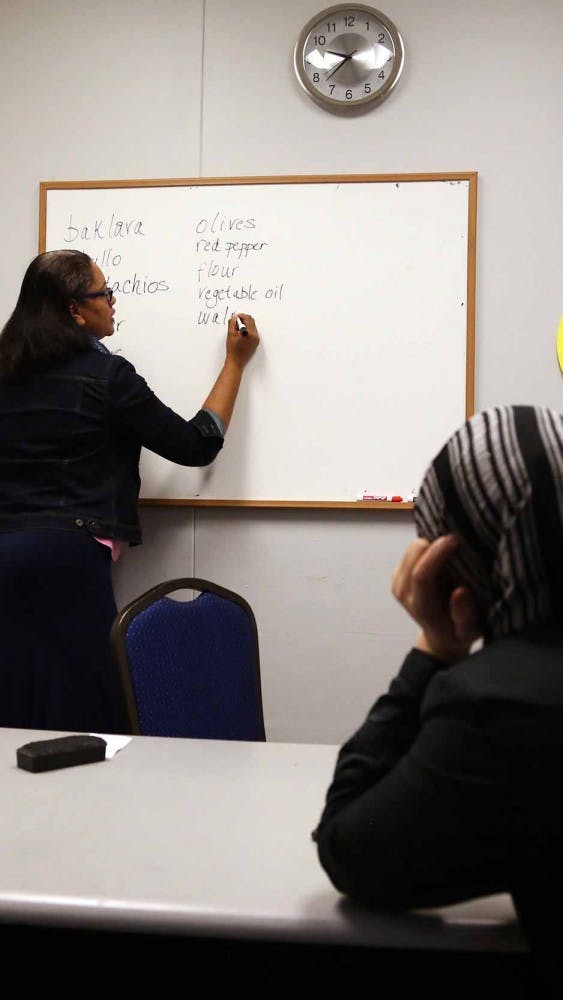 Lona, 34, sits in her Saturday morning English tutoring session on Oct. 24. The theme of the session was food and preparing dishes. Nina Gondola, a volunteer, keeps the lesson conversational to help Lona with her English. Lona knows very little English, and Gondola doesn't speak Arabic.