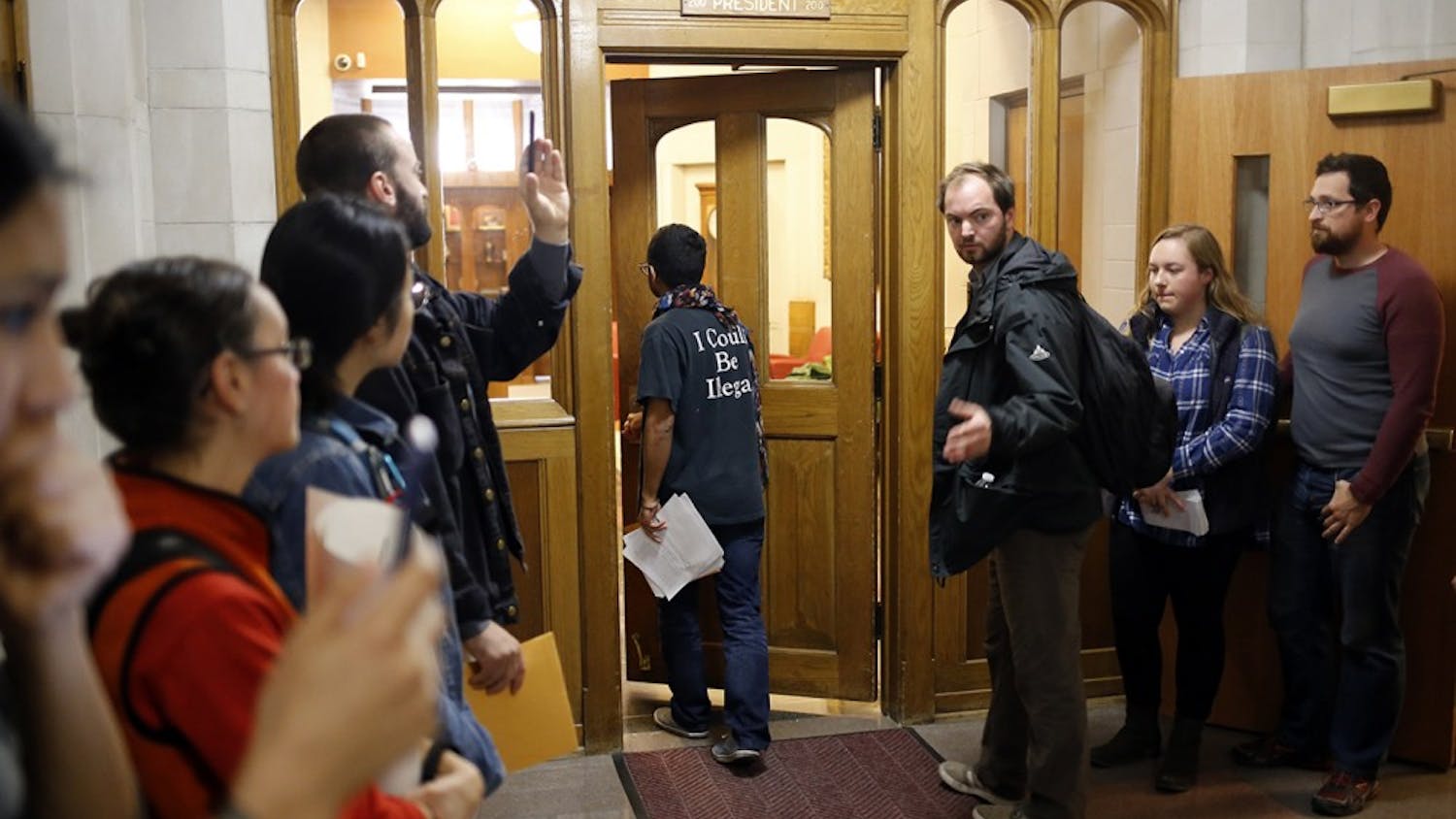 Willy Palomo delivers a list of demands to President McRobbie during a rally for a Sanctuary Campus Wednesday. "We are demanding that they meet with undocumented students by Tuesday, November 29th, or we will give them hell," Palomo later said.