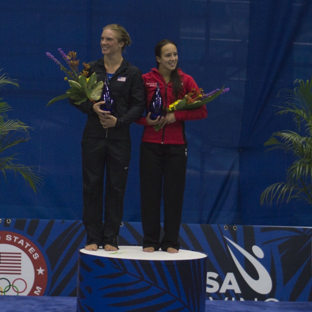 Katrina Young and IU diver Jessica Parratto accept their awards after qualifying for Team USA in the women's 10-meter event Saturday at the IUPUI Natatorium.