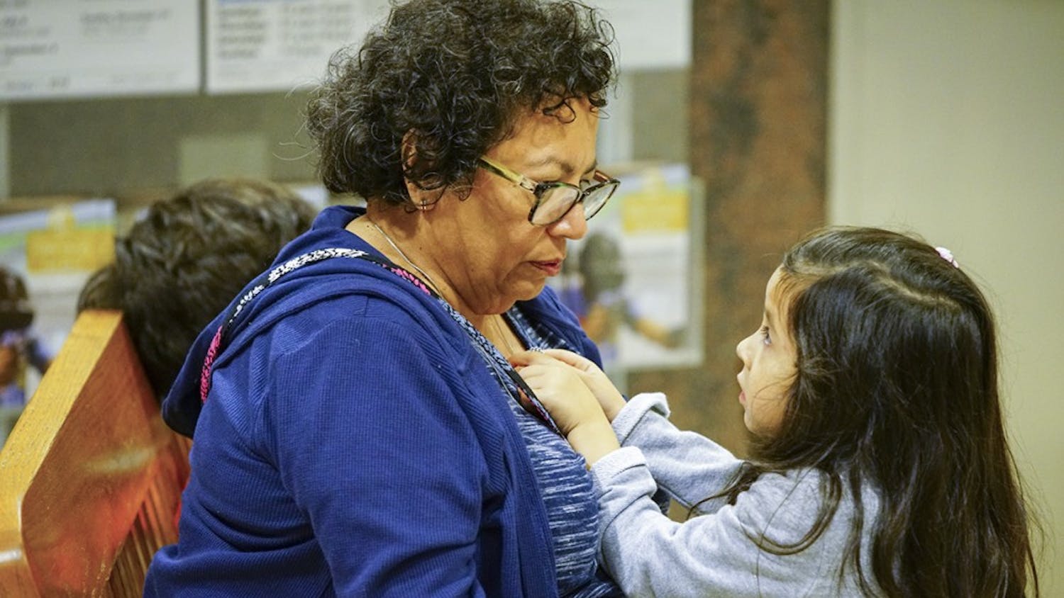 Elosia plays with her grandmother Rochelle Martin’s necklace during the Hispanic Heritage Day Celebration on Sunday afternoon in the Monroe County Public Library.&nbsp;