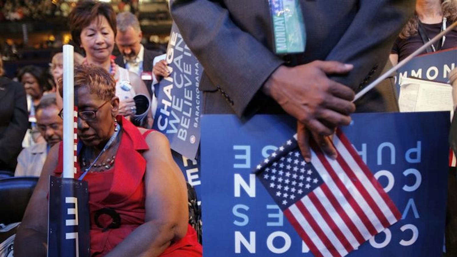 Delegate Carrie Austin, of Chicago, bows her head during the benediction at the close of the opening session of the Democratic National Convention Monday in Denver.