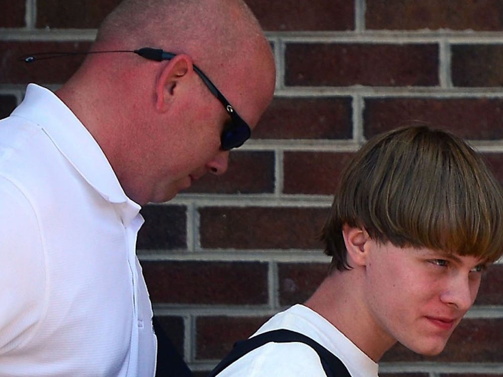 Charleston shooting suspect Dylann Roof is escorted from the Shelby Police Dept. Thursday, June 18, 2015 in Shelby, N.C. 
