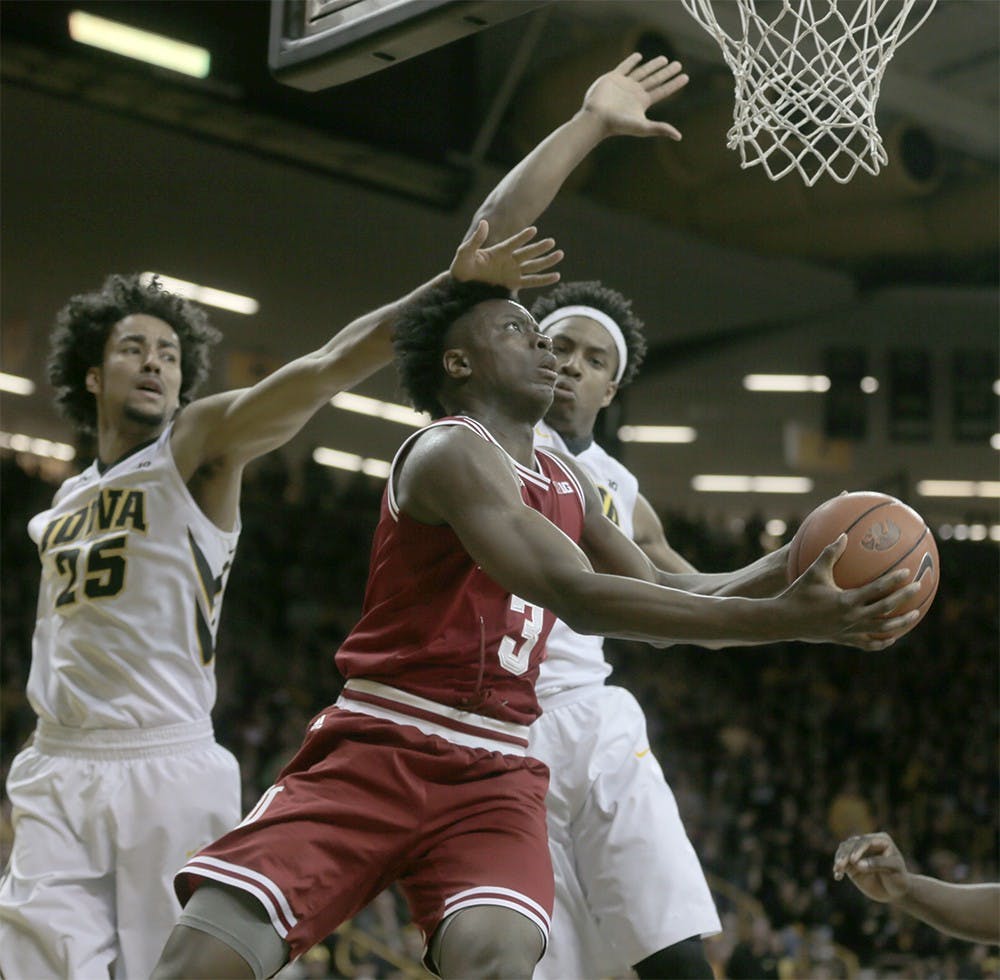 Freshman forward OG Anunoby attemps a layup against two Iowa defenders in IU's Tuesday win. (The Daily Iowan)