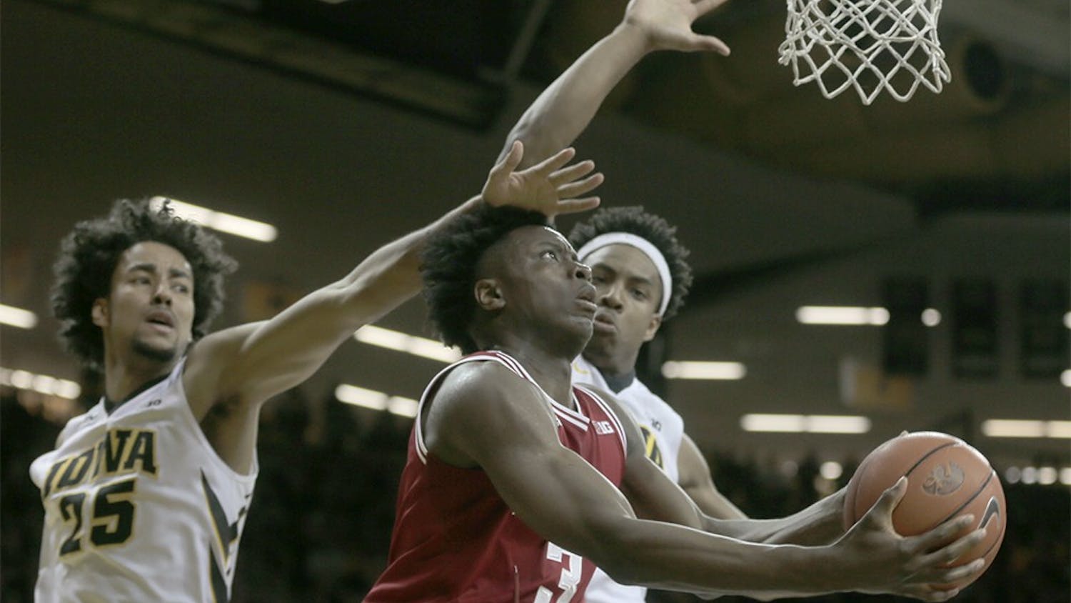 Freshman forward OG Anunoby attemps a layup against two Iowa defenders in IU's Tuesday win. (The Daily Iowan)