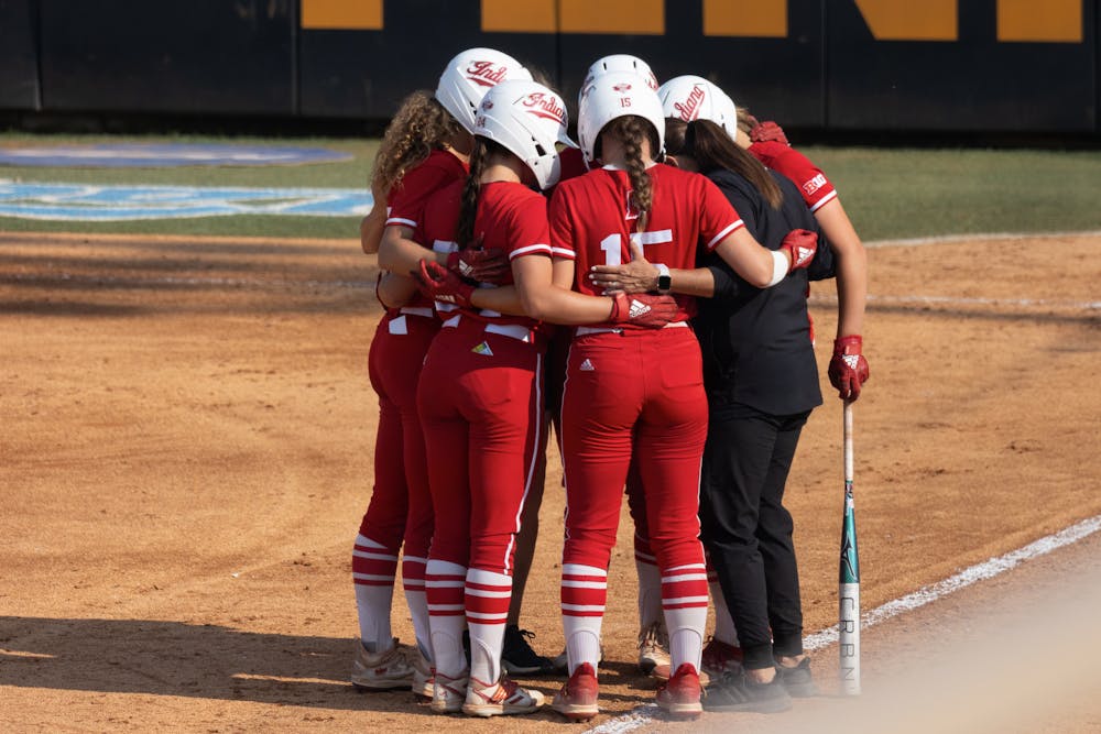Indiana softball players huddle at the NCAA Tournament against the University of Tennessee May 21. Two players entered their name into the transfer portal, according to a report Tuesday morning. 