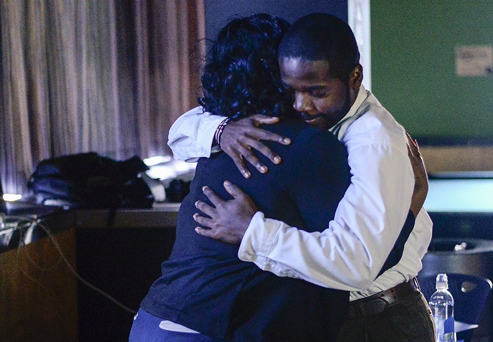 Richard Dixon hugs senior Nichelle Whitney after she shared her experience with suicide Tuesday at the Hoosier Den. The Gamma Delta chapter of Iota Phi Theta fraternity organized the suicide awareness event, which gave students the opportunity to share how suicide has impacted their lives.
