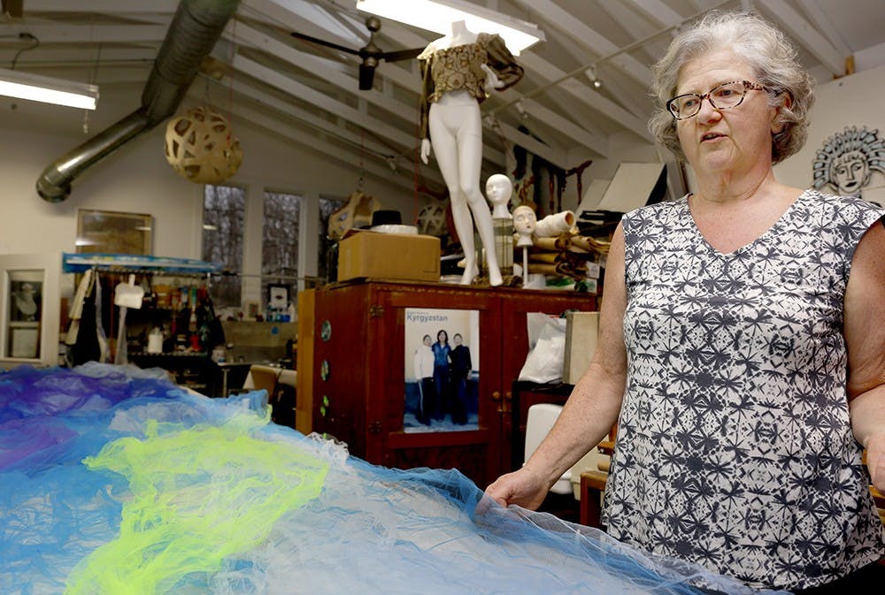 Gail Hale shows a recycled fabric, picked up at a sorority house Tuesday at her house. Hale has been using recycled materials to create art objects ever since she was young. She contributed making desinging a background stage during TedXBloomington by using recycled materials in 2012. She plans to use it for upcoming the Trashion and Refashion event. 