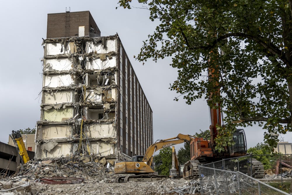 <p>A construction crew works on razing IU&#x27;s historic Poplars Building on Aug. 30, 2022, along East Seventh Street. The building was originally built in 1964 to be a luxury dorm for female students before it transitioned into a hotel in 1967.</p>