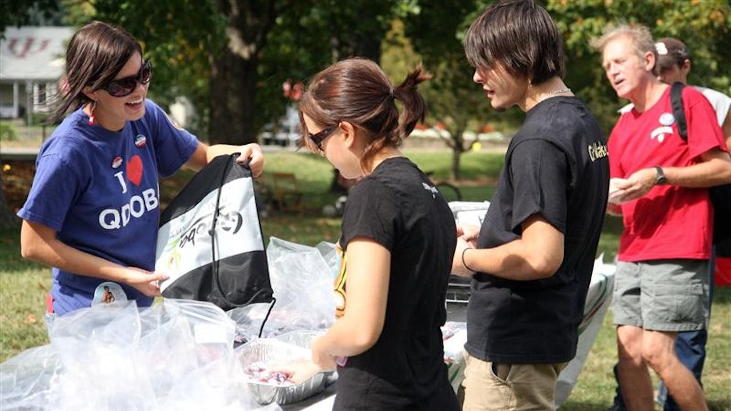 Jackie Knowles, left, an employee for the marketing department of Qdoba Mexican Grill, sorts through buttons for the 2008 Presidential Election Saturday afternoon in Dunn Meadow, to encourage people to vote. Qdoba offered free food as part of the Get Out the Vote concert, put on by INPIRG.