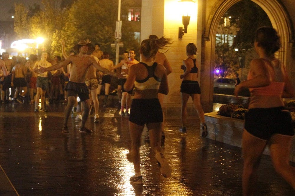 Runners cross the finish line at Sample Gates during the Nearly Naked Mile run Wednesday. Approximately 1,500 students participated in the run, which benefited the United Way through monetary and clothing donations.